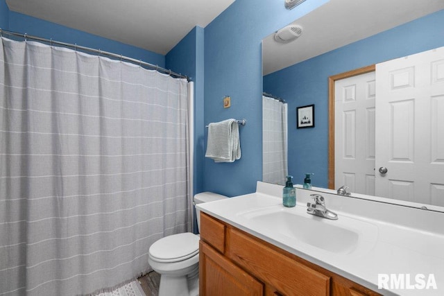 bathroom with vanity and toilet