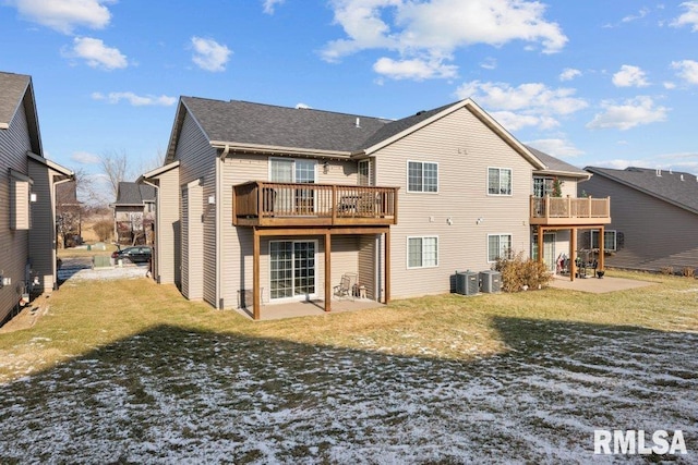 rear view of property with a lawn, a wooden deck, a patio, and central AC unit