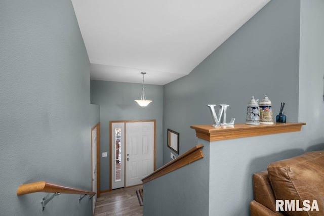 entryway with hardwood / wood-style floors and lofted ceiling