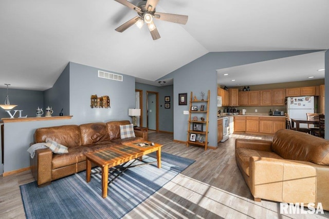 living room with ceiling fan, light hardwood / wood-style floors, and lofted ceiling