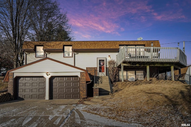 view of front of house with a garage and a deck