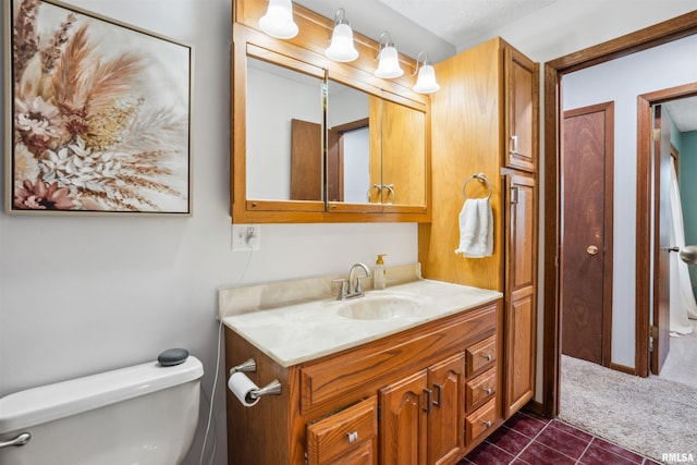 bathroom with toilet and vanity