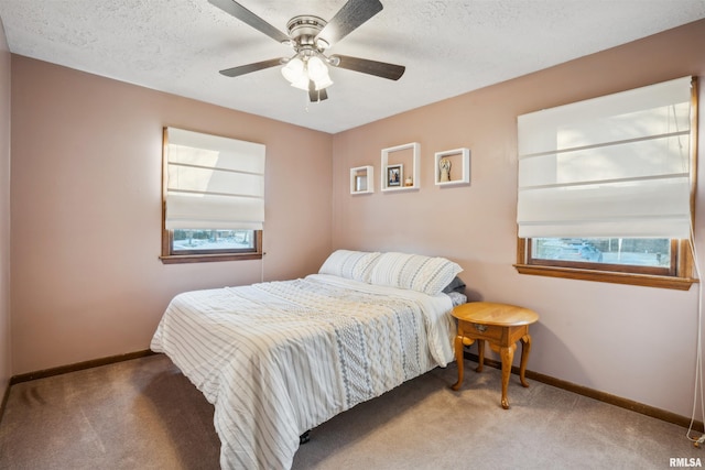 bedroom with carpet flooring, a textured ceiling, and ceiling fan