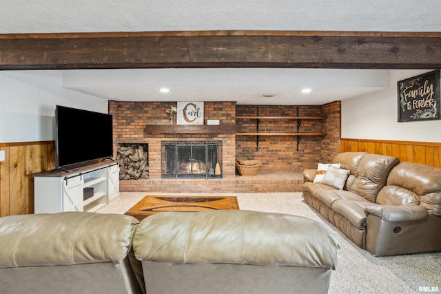 carpeted living room featuring a fireplace, built in features, wooden walls, and beamed ceiling