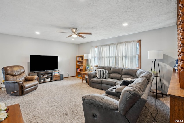 living room featuring a textured ceiling, ceiling fan, and carpet flooring