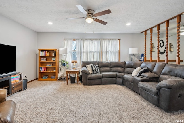 carpeted living room featuring a textured ceiling and ceiling fan