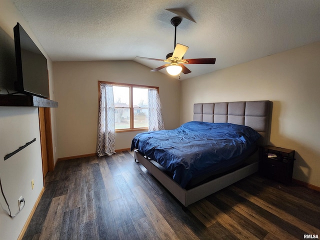 bedroom featuring a textured ceiling, ceiling fan, dark hardwood / wood-style flooring, and vaulted ceiling