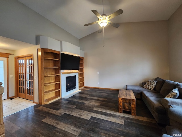 unfurnished living room featuring hardwood / wood-style flooring, high vaulted ceiling, and ceiling fan