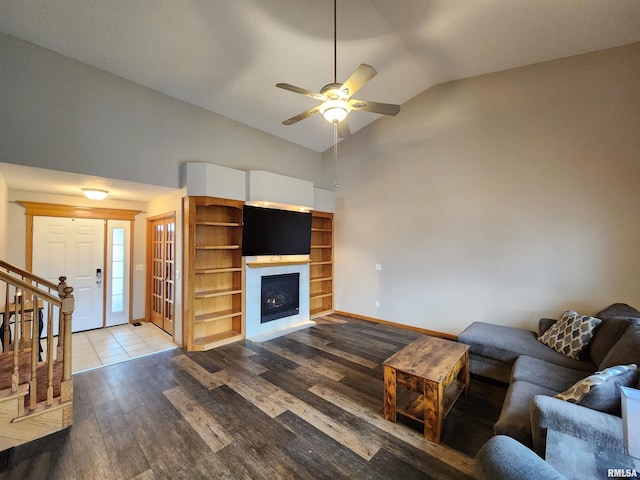 living room with hardwood / wood-style floors, ceiling fan, and lofted ceiling