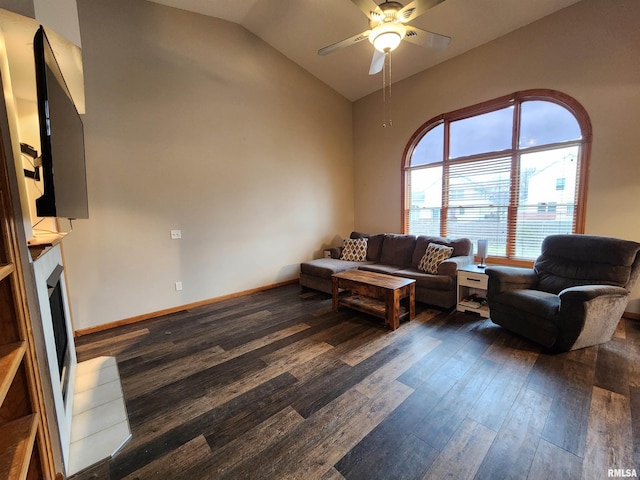 living room featuring ceiling fan, dark hardwood / wood-style flooring, and vaulted ceiling