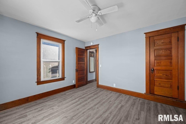 unfurnished bedroom with ceiling fan and light wood-type flooring