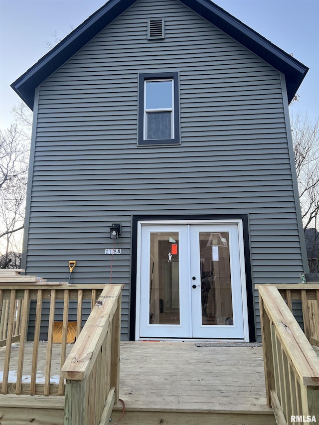 rear view of house with a deck and french doors