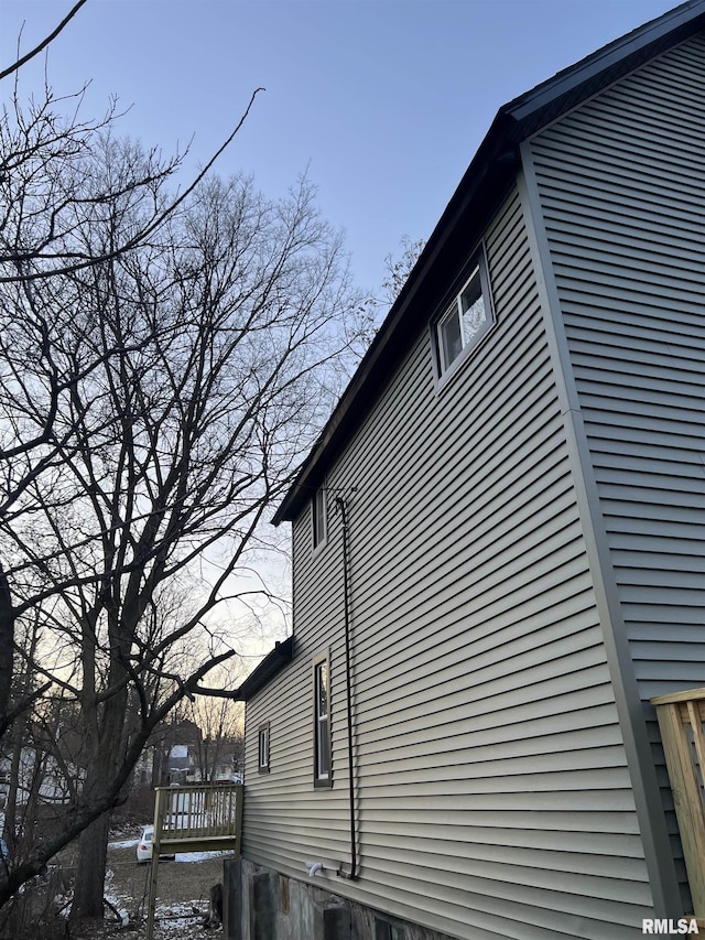 view of home's exterior featuring a wooden deck