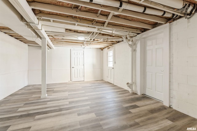 basement with hardwood / wood-style flooring