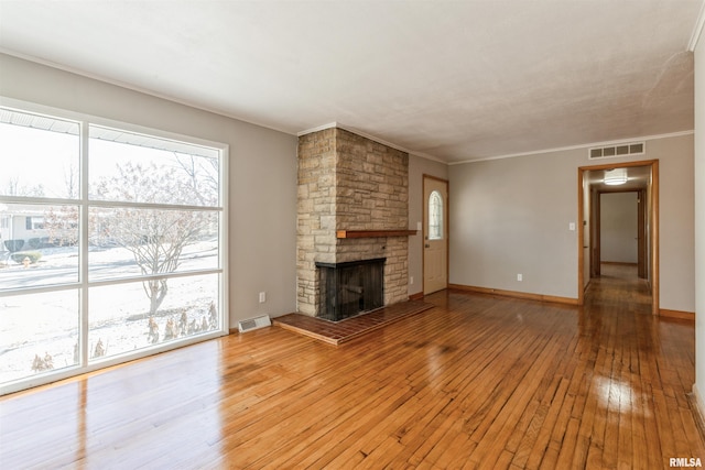 unfurnished living room featuring crown molding, a fireplace, and light hardwood / wood-style flooring