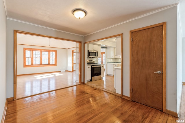 interior space with light hardwood / wood-style floors and crown molding