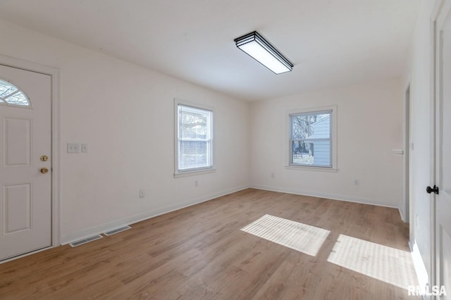 foyer entrance with light wood-type flooring