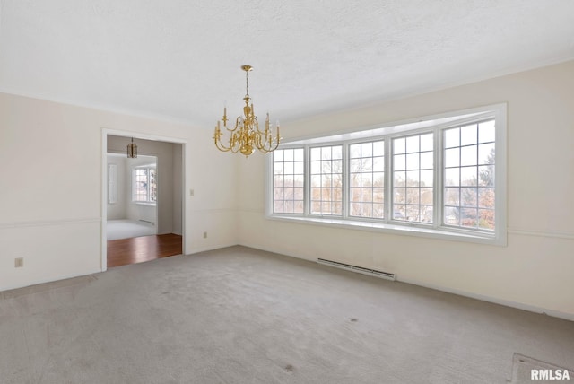 empty room featuring a textured ceiling, an inviting chandelier, crown molding, and carpet floors