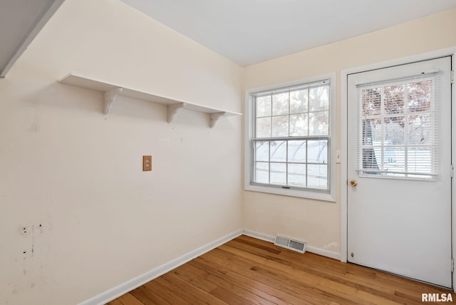 laundry room featuring light wood-type flooring and a wealth of natural light