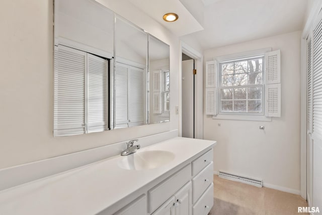 bathroom with vaulted ceiling, vanity, and a baseboard radiator