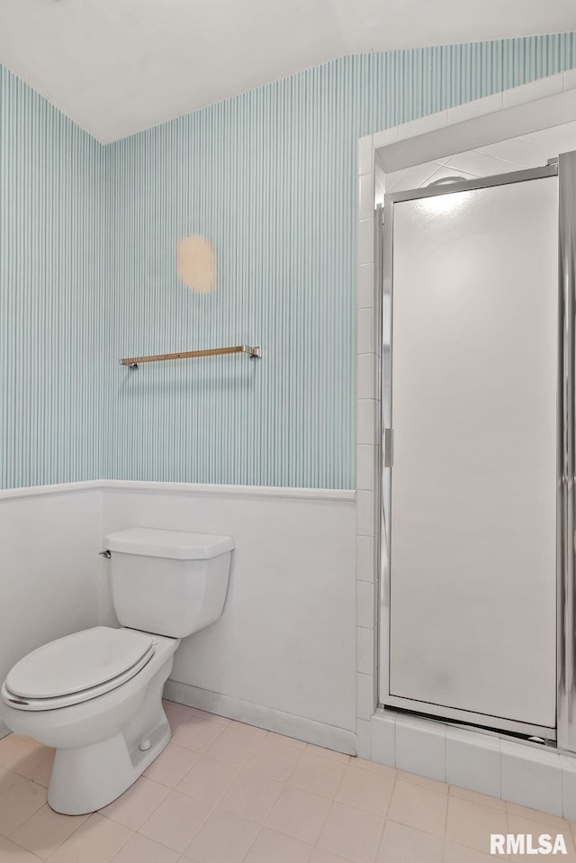 bathroom featuring an enclosed shower, tile patterned flooring, and toilet