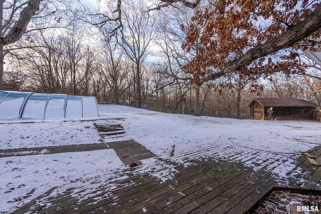 yard covered in snow with an outdoor structure