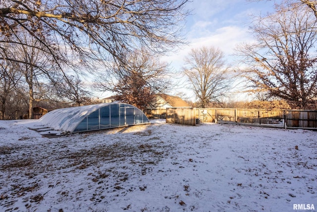 yard layered in snow with an outbuilding