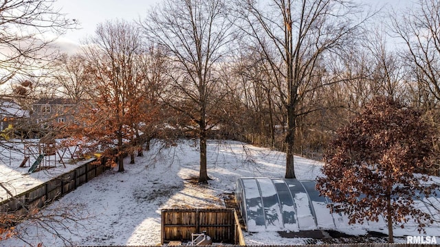 yard covered in snow featuring an outbuilding