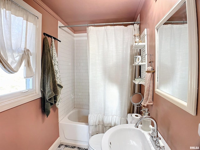 bathroom featuring ornamental molding, sink, and shower / tub combo