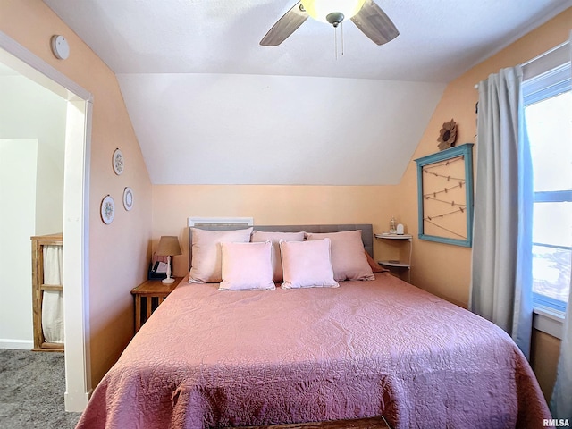 bedroom featuring vaulted ceiling, carpet floors, and ceiling fan