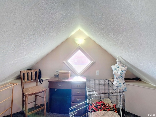 bedroom featuring vaulted ceiling, a textured ceiling, and carpet