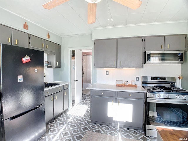 kitchen featuring gray cabinetry, ornamental molding, ceiling fan, and appliances with stainless steel finishes