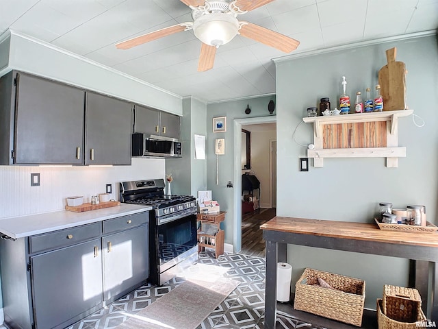 kitchen featuring gray cabinetry, ornamental molding, stainless steel appliances, and ceiling fan