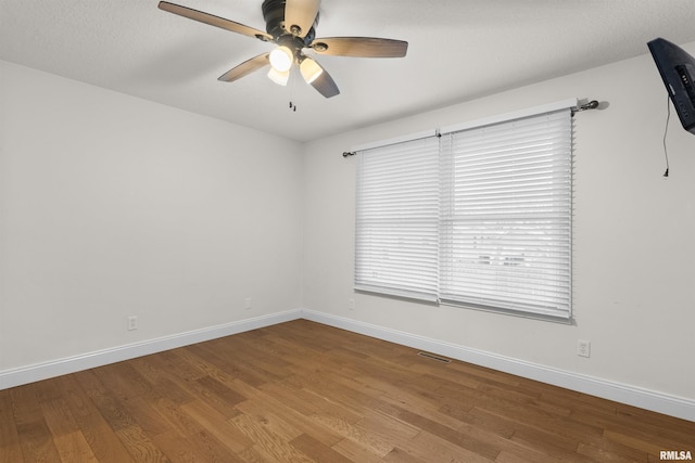 spare room with ceiling fan, light hardwood / wood-style flooring, and a textured ceiling