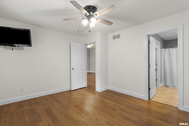 unfurnished bedroom featuring hardwood / wood-style floors and ceiling fan