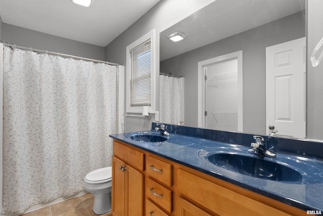 bathroom featuring tile patterned floors, vanity, and toilet