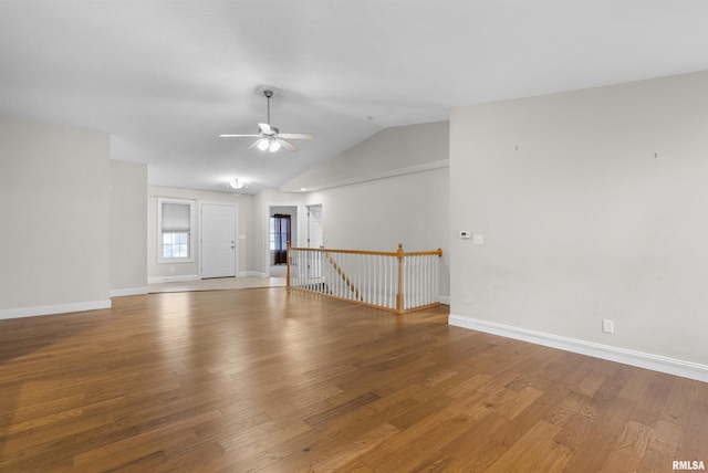 spare room featuring ceiling fan, wood-type flooring, and vaulted ceiling