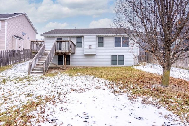 snow covered property with a wooden deck