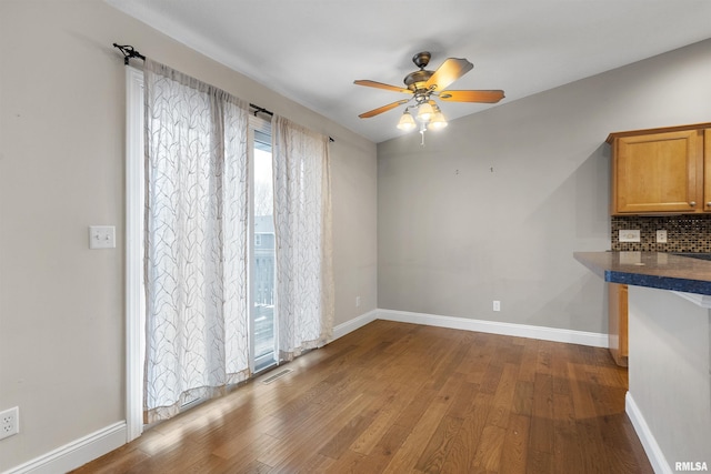 interior space featuring wood-type flooring and ceiling fan