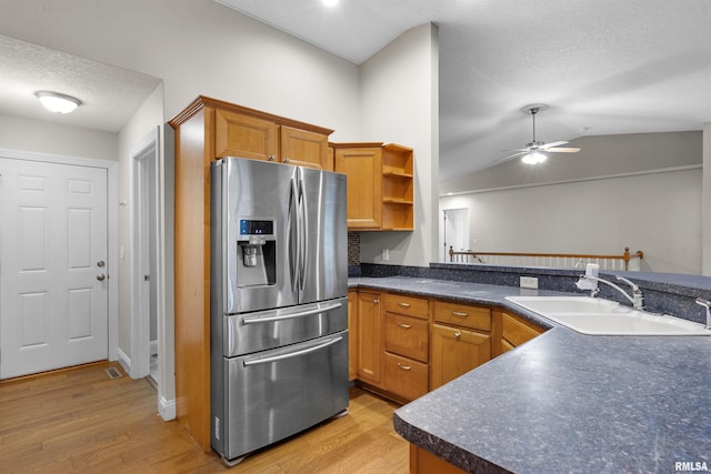 kitchen featuring kitchen peninsula, ceiling fan, stainless steel fridge with ice dispenser, and sink