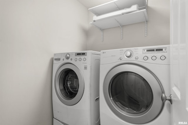 clothes washing area with washer and clothes dryer