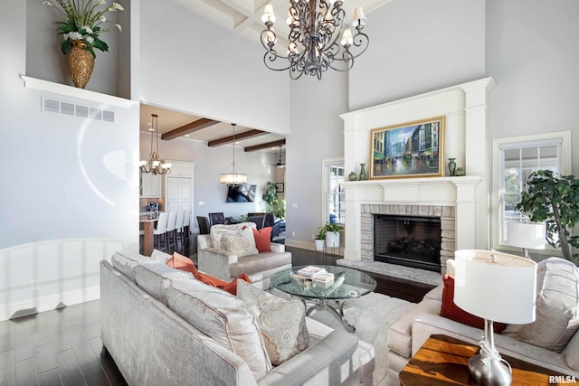 living room with beamed ceiling, a high ceiling, dark hardwood / wood-style floors, and a fireplace