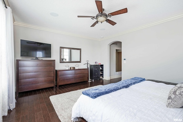 bedroom featuring dark hardwood / wood-style floors, ceiling fan, and crown molding