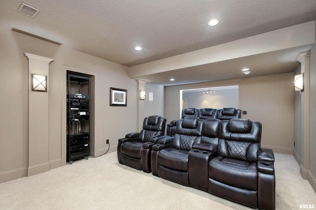 carpeted home theater with a textured ceiling