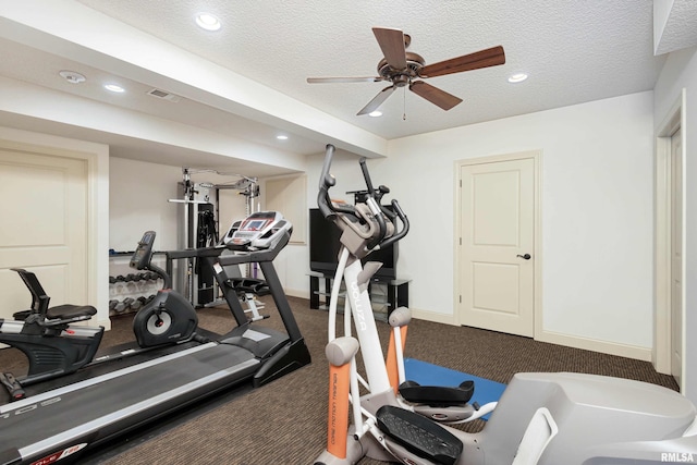 exercise room featuring a textured ceiling