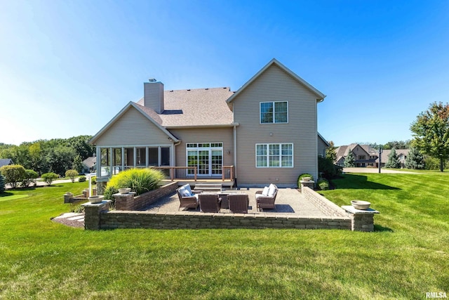 back of property with outdoor lounge area, a patio, and a lawn