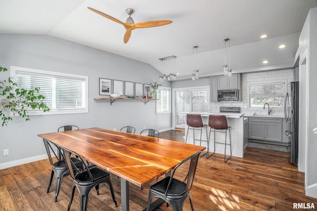 dining area with sink, ceiling fan, vaulted ceiling, and plenty of natural light