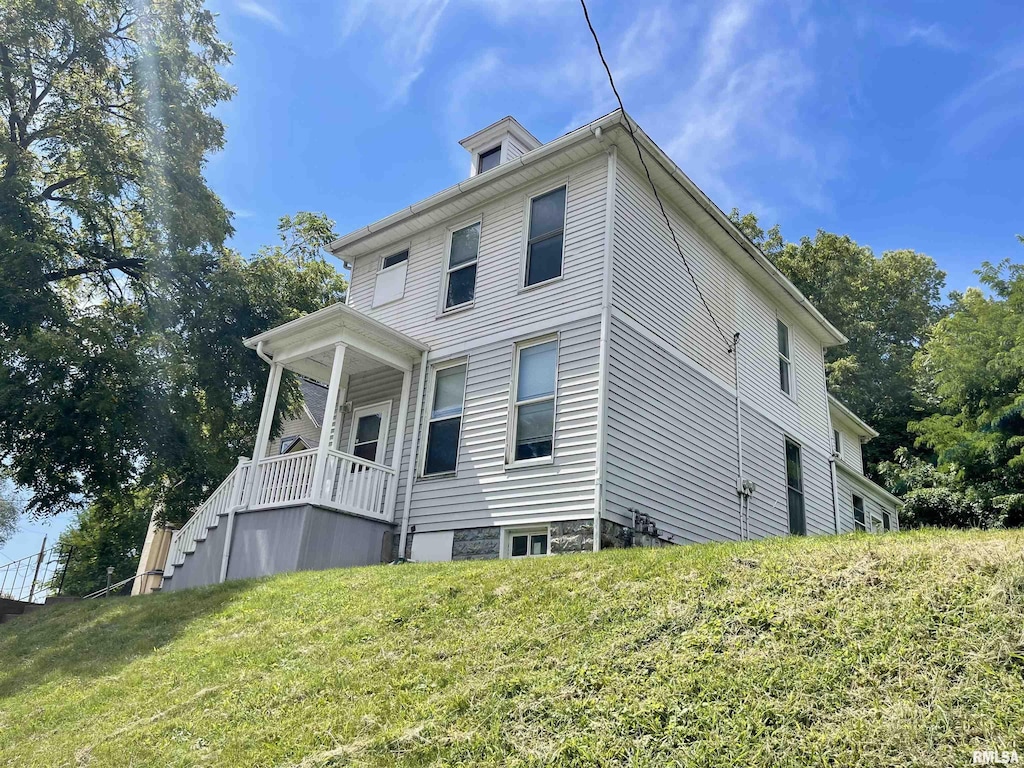 view of side of property with a yard