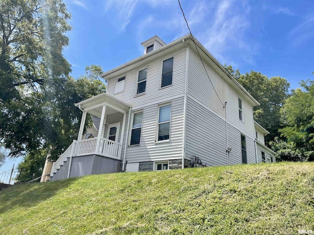 view of side of property with a yard