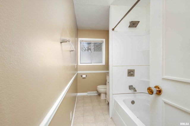 bathroom with toilet and bathing tub / shower combination